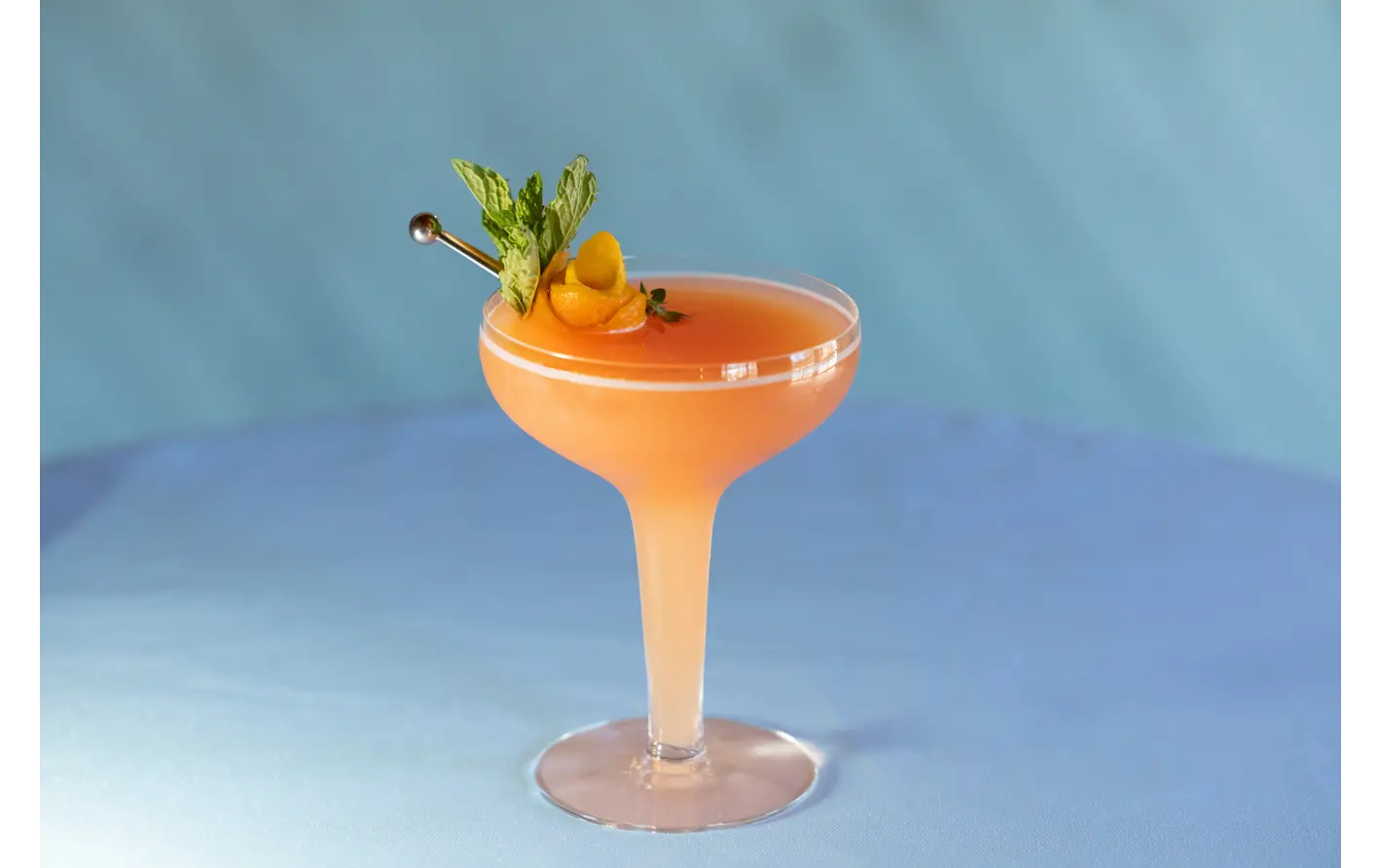 Apricot brandy sour with petal garnish. Recipe by Ethan Guillemette.